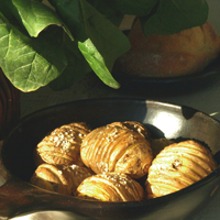 Hasselbacks potatoes in a brown bowl